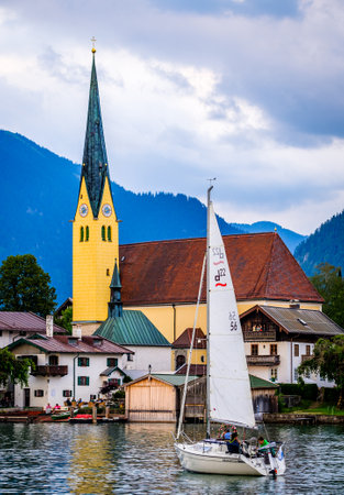 Rottach-Egern, Germany - July 9: boat with passengers in front of the church of Rottach-Egern on July 9, 2019のeditorial素材