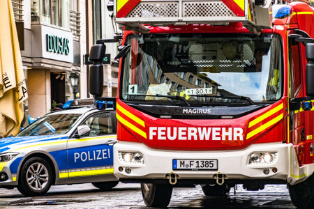 Munich, Germany - February 11: typical german fire trucks and police car in Munich theatinerstrasse on February 11, 2020のeditorial素材