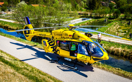 Egling, Germany - April 23: rescue helicopter during a mission near the isar river in egling on...