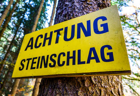 rock fall warning sign in germany - translation: look out - rocks fallingの写真素材