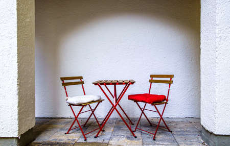 table and chairs at a sidewalk restaurant in italyの写真素材