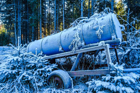 old water container trailer at a fieldの写真素材
