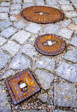 old manhole at a street - photo