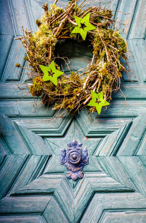 typical old wreath at a doorの写真素材