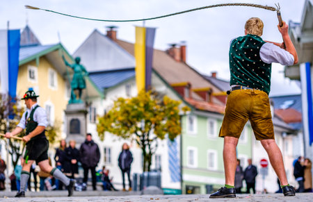 Bad Toelz, Germany - November 6: coachman with traditional clothes and popping whip at the annual leonhardifahrt procession on November 6, 2019 in bad toelz, Germanyのeditorial素材