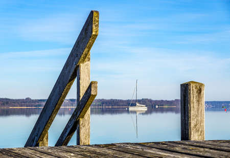 old wooden jetty at a lake in bavaria - germanyの写真素材