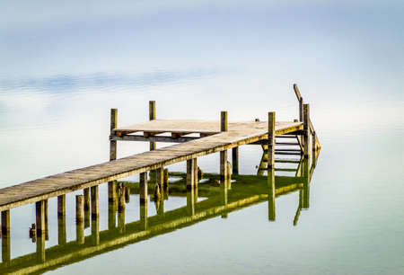 old wooden jetty at a lake in bavaria - germanyの写真素材