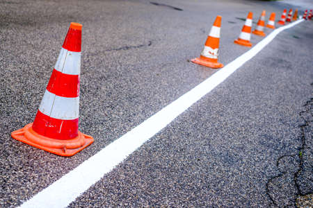 traffic cone and road marking at a streetの写真素材