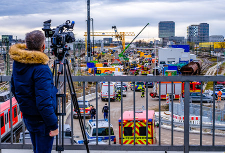 Munich, Germany - December 1: A cameraman in front of a large-scale deployment of the police and fire brigade after a bomb from WWII exploded at the Donnersberger BrÃ¼cke in Munich on December 1, 2021のeditorial素材