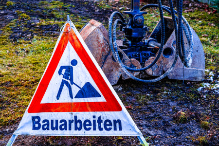 men at work warning sign in germany - translation: under constructionの写真素材