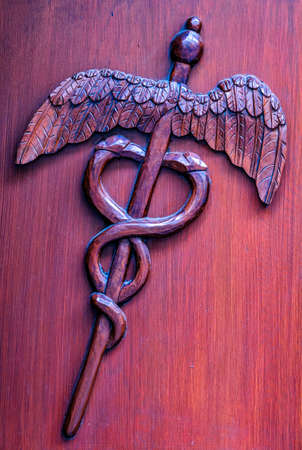 closeup of an antique Caduceus sign - photo