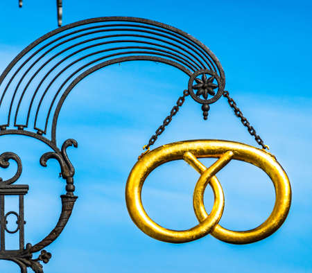 old pretzel sign at a bakery in austria - photo