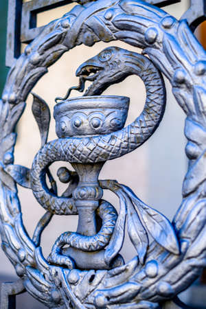 closeup of an antique Caduceus sign - photo