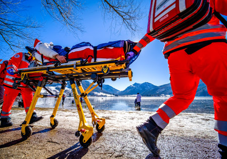 Schliersee, Germany - February 14: paramedics work with a stretcher near the frozen lake in Schliersee on February 14, 2021のeditorial素材