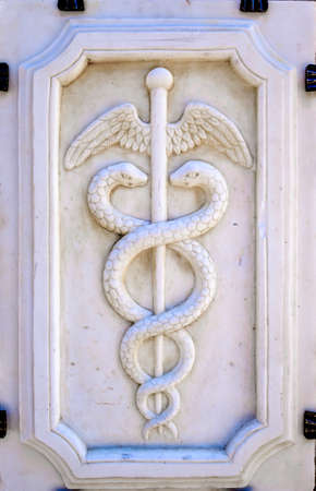 closeup of an antique Caduceus sign - photoの写真素材