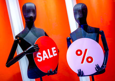 typical sale sign at a mannequin - photoの写真素材