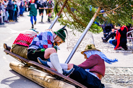 Mittenwald, Germany - February 24: Participants of a parade with traditional historic costumes to drive out the winter called 'maschkera' in Mittenwald on February 24, 2022のeditorial素材