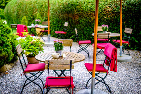 table and chairs at a sidewalk restaurant - photoの写真素材