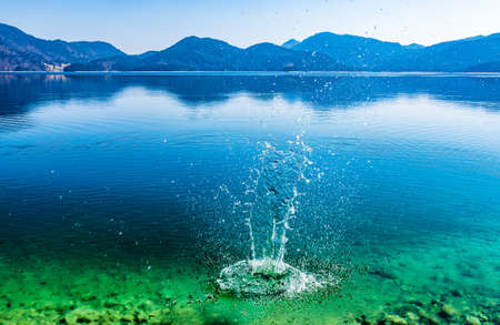 water splash at a lake in bavaria - walchenseeの写真素材