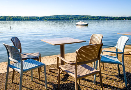 table and chairs at a sidewalk cafe - photoの写真素材