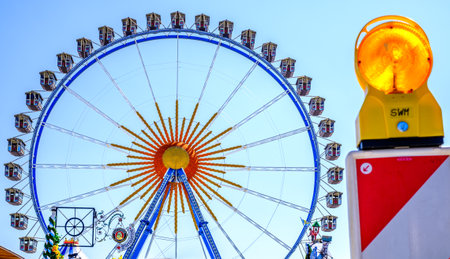 Munich, Germany - April 27: typical rides, ferries wheel, roller coaster at the annual spring festival (Fruhllingsfest) in munich on April 27, 2022のeditorial素材