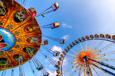 Munich, Germany - April 27: typical rides, ferries wheel, roller coaster at the annual spring festival (Fruhllingsfest) in munich on April 27, 2022のeditorial素材