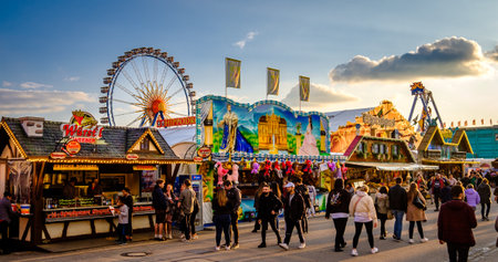 Munich, Germany - April 27: visitors, typical amusement parks rides and stands at the annual spring festival (Fruhllingsfest) in Munich on April 27, 2022のeditorial素材