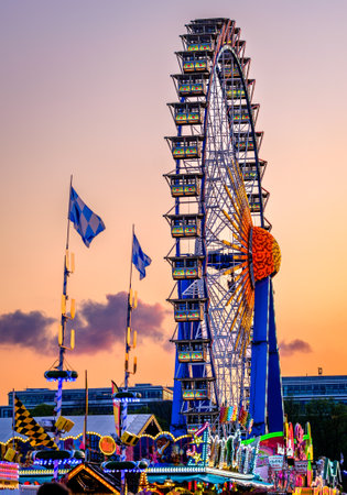 Munich, Germany - April 27: typical rides, ferries wheel, roller coaster at the annual spring festival (Fruhllingsfest) in munich on April 27, 2022のeditorial素材