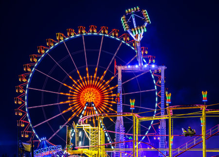 Munich, Germany - April 27: typical rides, ferries wheel, roller coaster at the annual spring festival (Fruhllingsfest) in munich on April 27, 2022のeditorial素材