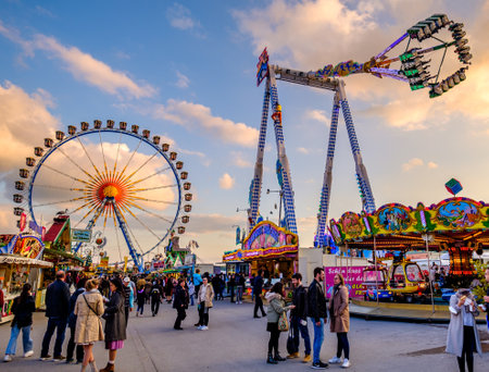 Munich, Germany - April 27: visitors, typical amusement parks rides and stands at the annual spring festival (Fruhllingsfest) in Munich on April 27, 2022のeditorial素材