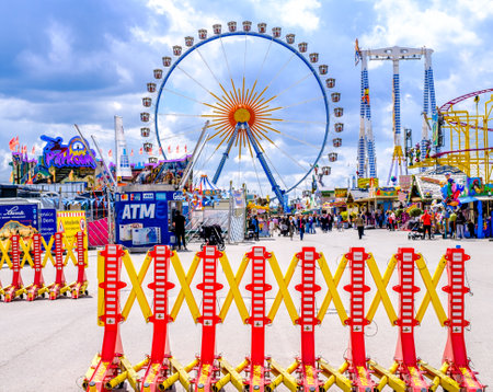 Munich, Germany - May 3: typical rides, ferries wheel, roller coaster at the annual spring festival (Fruhllingsfest) in munich on May 3, 2022のeditorial素材