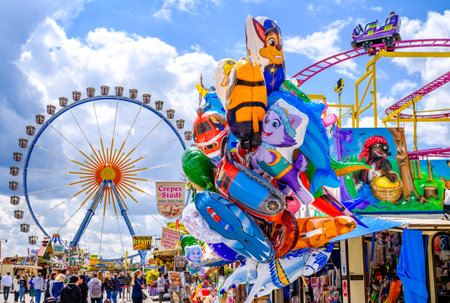 Munich, Germany - May 3: typical rides, ferries wheel, roller coaster at the annual spring festival...