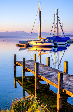 old jetty and sailboats in tutzing - bavaria - germanyの写真素材