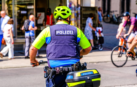 Munich, Germany - May 19: typical police officers with bicycles at the old town of Munich on May 19, 2022のeditorial素材