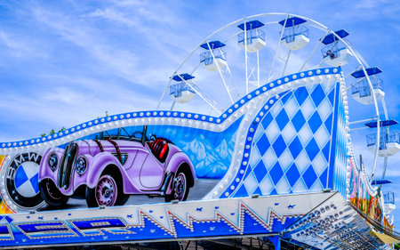 Murnau, Germany - July 14: typical bavarian blue white ferris wheel at a traveling carnival Murnau on July 14, 2022のeditorial素材