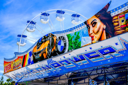 Murnau, Germany - July 14: typical bavarian blue white ferris wheel at a traveling carnival Murnau on July 14, 2022のeditorial素材