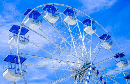 Murnau, Germany - July 14: typical bavarian blue white ferris wheel at a traveling carnival Murnau on July 14, 2022のeditorial素材