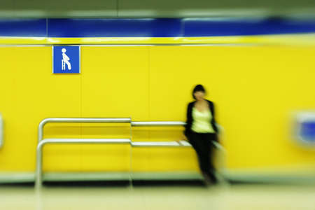 Young woman waiting for train on metro platformの写真素材