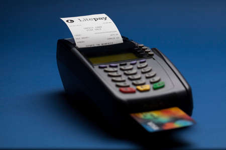 Pos credit card terminal with a sample mockup receipt for litecoin cryptocurrency payment