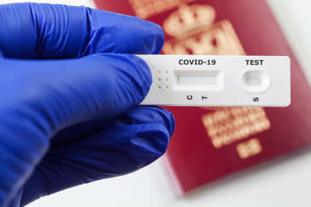 COVID-19 virus disease rapid swab test, Coronavirus worldwide crisis, global pandemic outbreak, hand in blue gloves at airport customs, security check, quick antigen antibody testing kit illustrationの写真素材