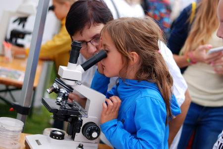An Unidentified Girl Looks Through the Microscopeのeditorial素材