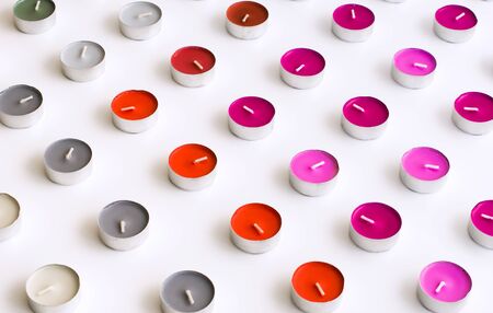 Arranged Tea Candles on White Background Deskの写真素材