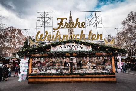 Vienna, Austria - December 10 2018: Day shot of Christmas markets at Rathausplatz, the main text frohe weihnachten behind entrance gateのeditorial素材