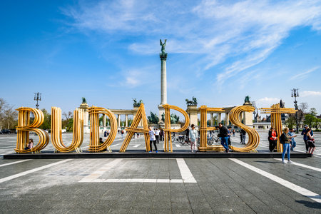 Budapest, Hungaria - April 9 2019: Text Budapest made from wood on Heroes' Square, Millennium Monument in the backgroundのeditorial素材