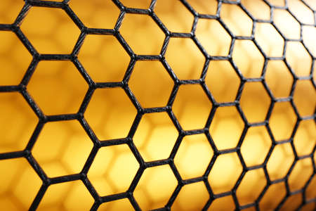 3D rendering of carbon nanotube on yellow background, black atoms and bondsの写真素材