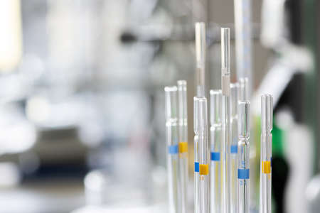 Detailed view at chemistry glass pippetes, blurred background