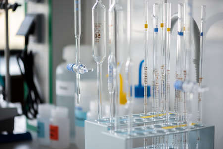 Detailed view at chemistry glass pippetes, blurred background
