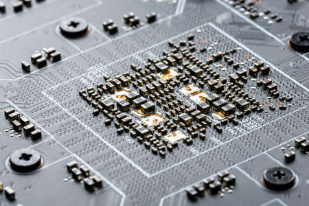 Electronic PCB printed circuit board in macro close-up with transistors circuitry and electric...
