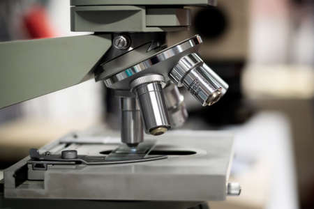 Close-up microscope with metal lens for laboratory research.の写真素材