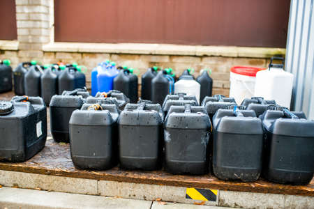 The storage of toxic waste and chemicals in plastic boxes on the factory premises of a chemical plant / Toxic waste chemical plantの写真素材